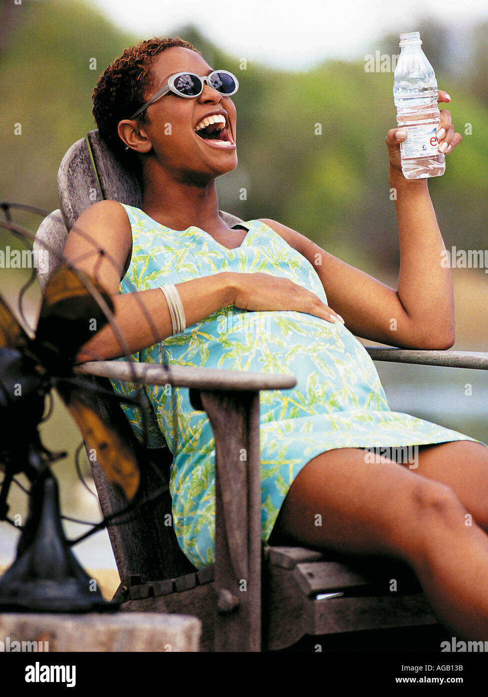 Pregnant Afro American woman with Evian water Stock Photo Alamy