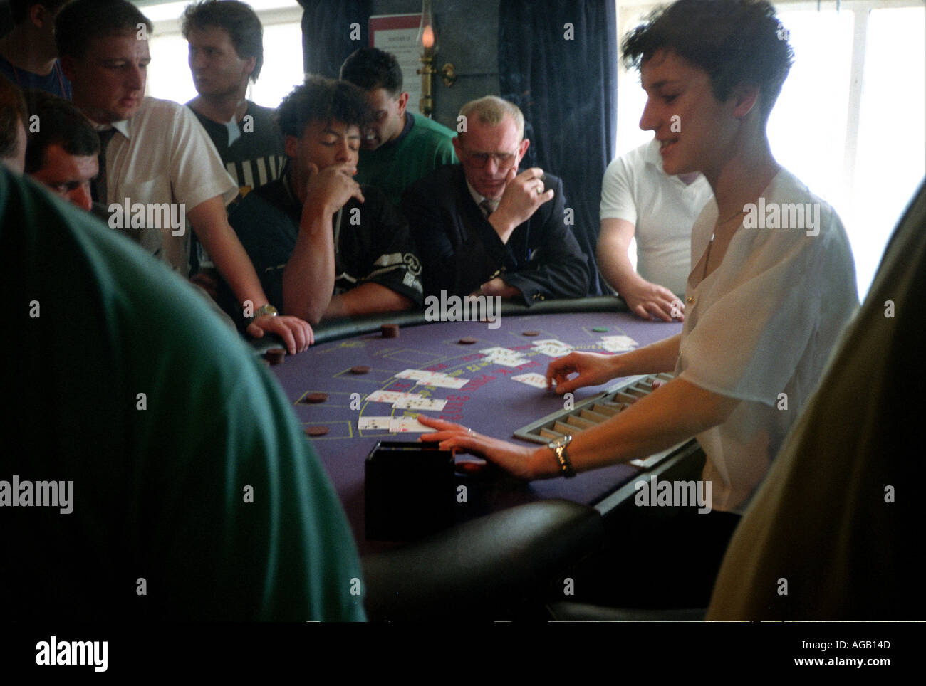Group of people gambling on board a cross channel ferry. Stock Photo