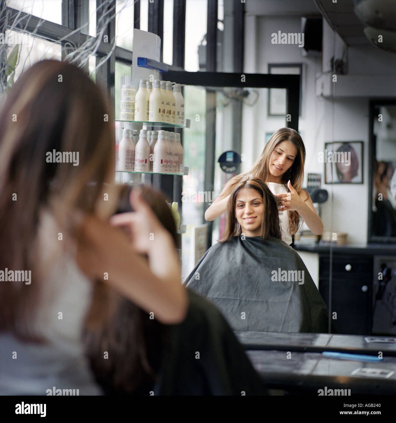Young Woman Hairdresser Cutting The Hair Of A Client East London