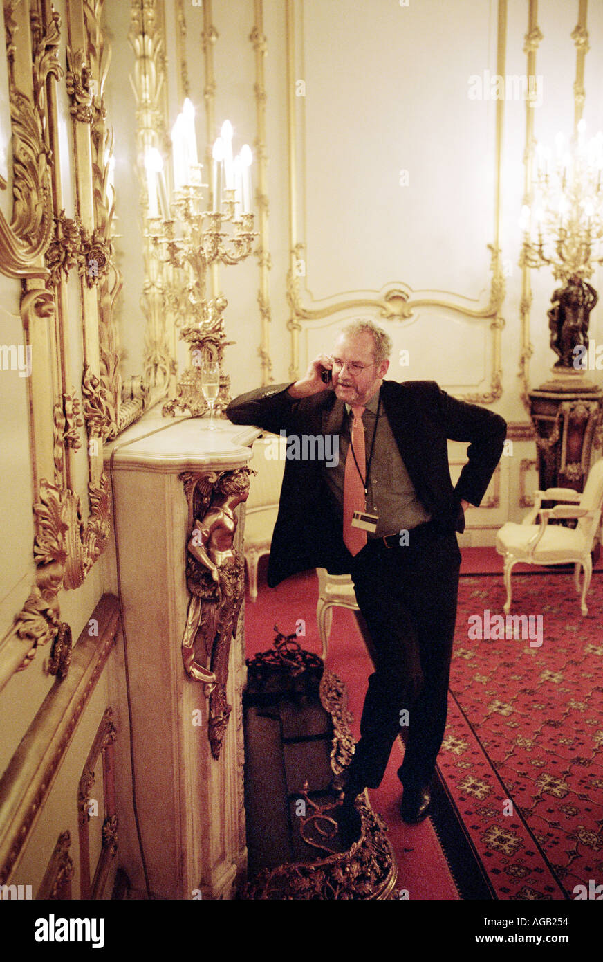 Man at a conference in Lancaster House London taking a call on his mobile phone  Stock Photo