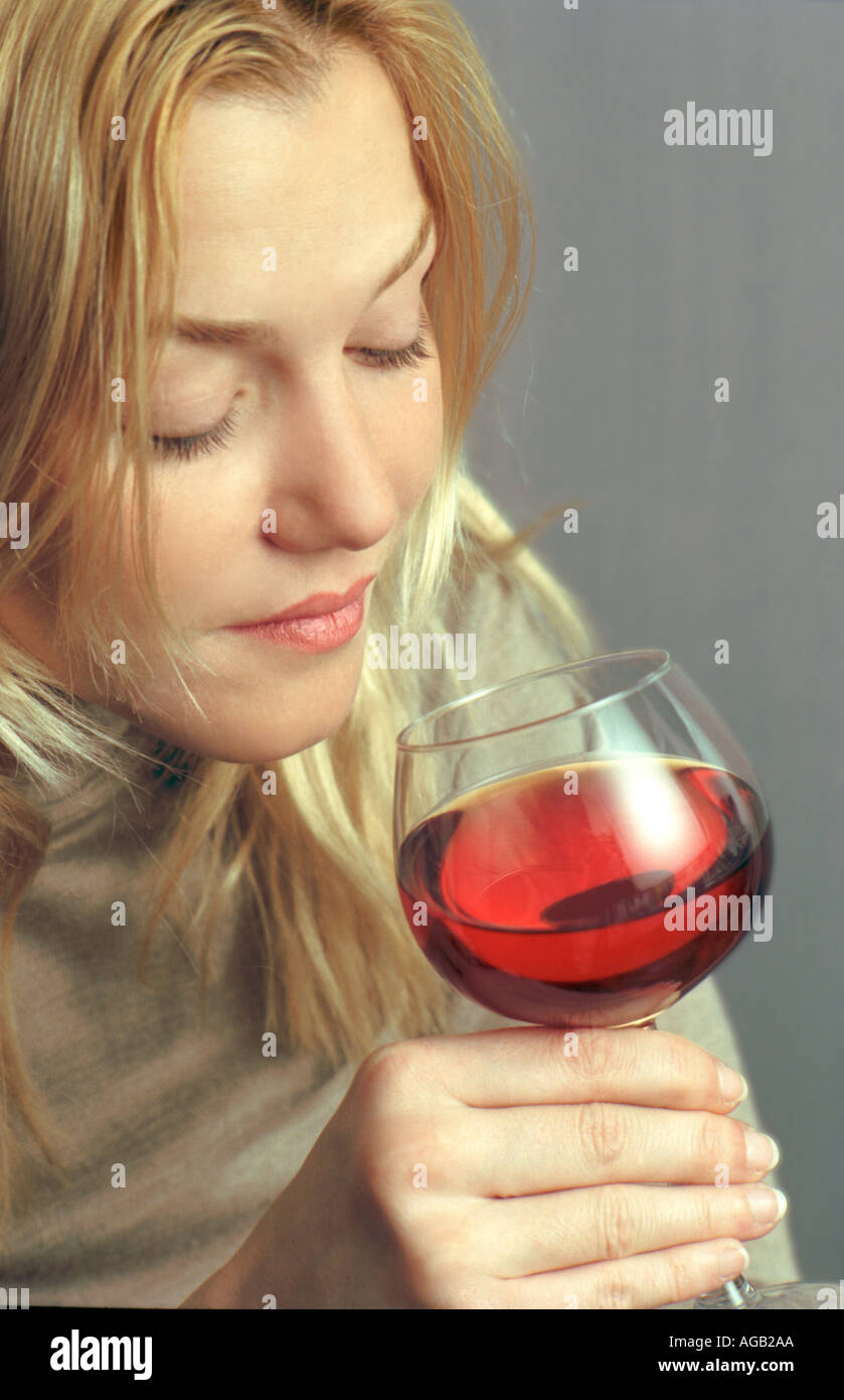 girl drinking wine, sniffing, Stock Photo