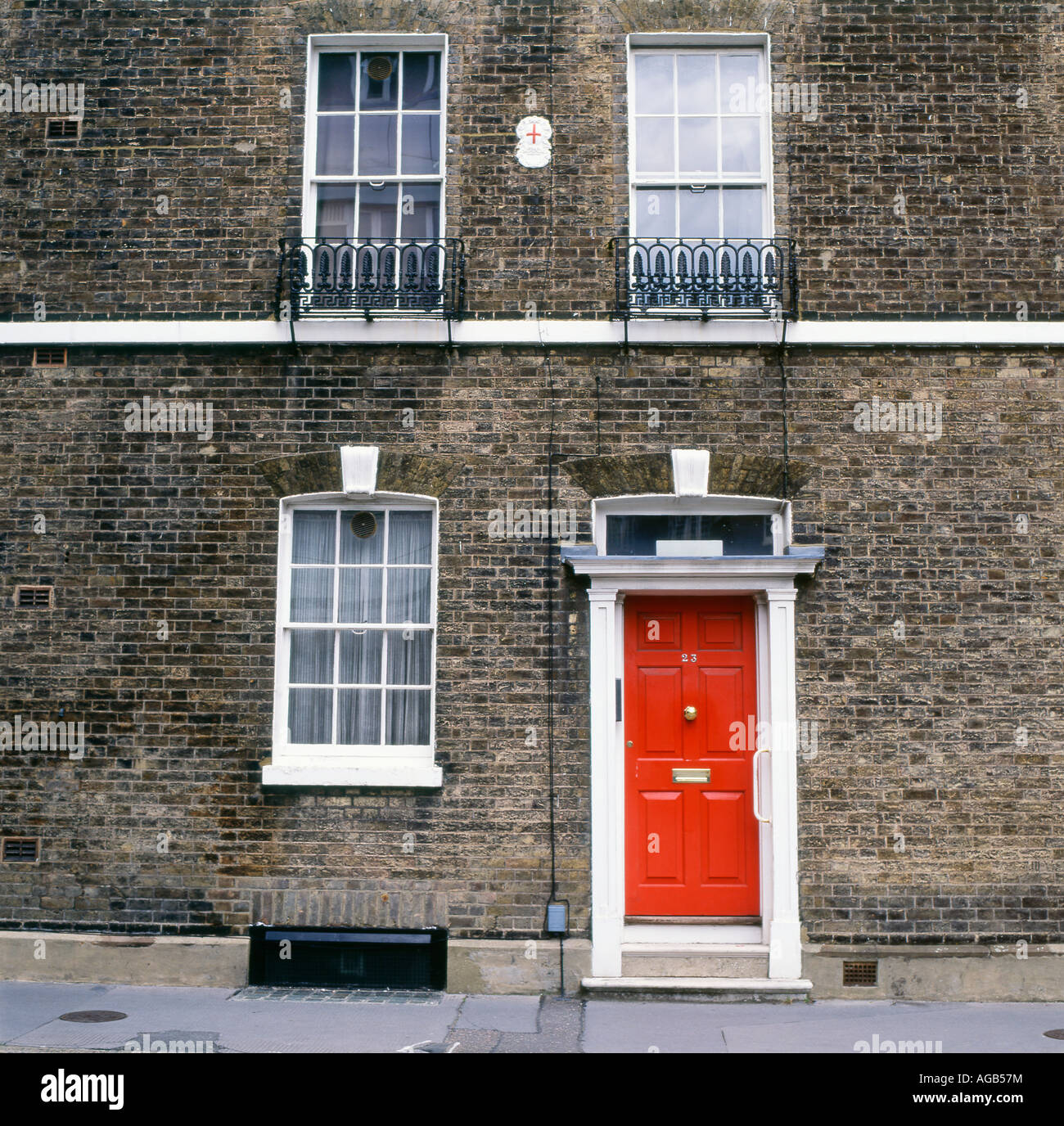 Exterior View Of Front Of House With Red Door Windows In A Row Of