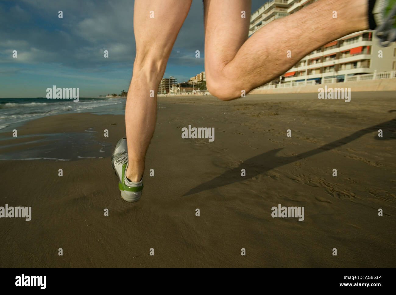 Close up of male runner s feet on beach Stock Photo Alamy