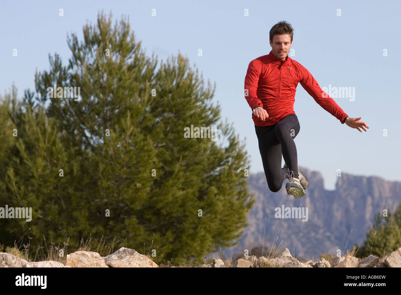 Male runner leaping Stock Photo