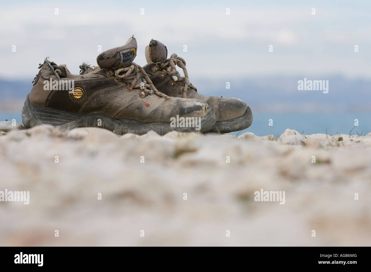 Old shoes on shingle beach Stock Photo Alamy