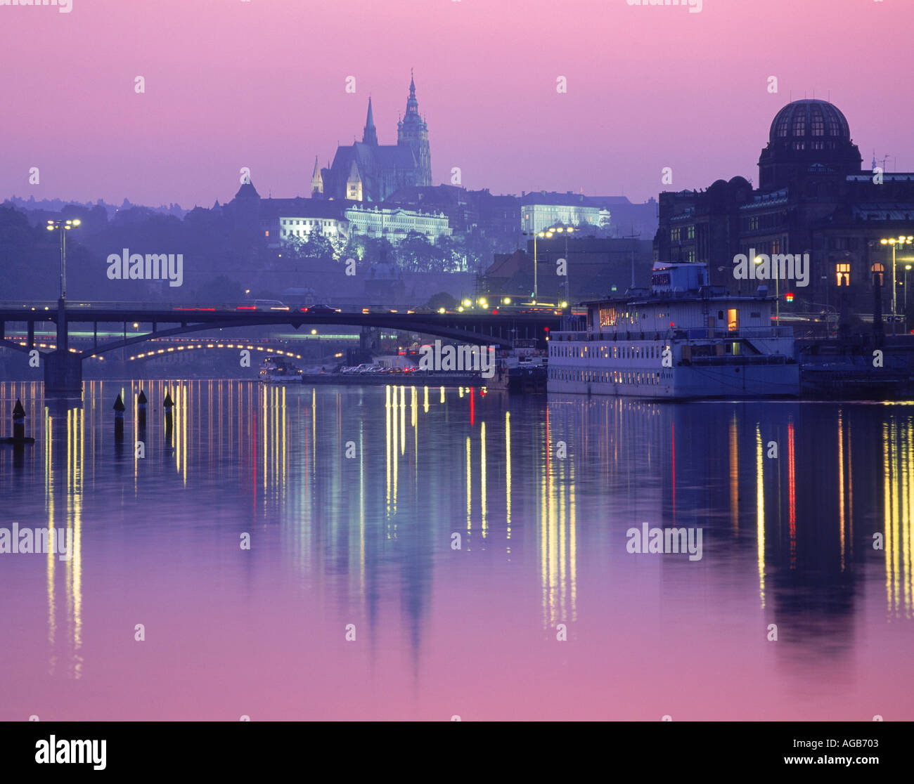 St Vitus Cathedral and Hradcany Castle reflecting off Vltava River at dusk in Prague Stock Photo