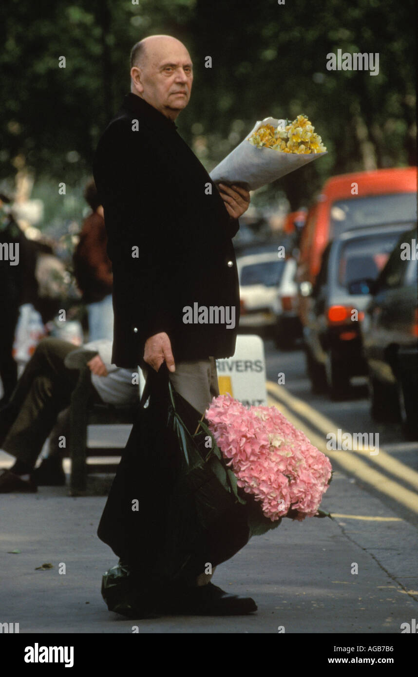 Last day of the Chelsea Flower show 1990s London UK. Visitor to the flower show taking home some of the displayed flowers HOMER SYKES Stock Photo
