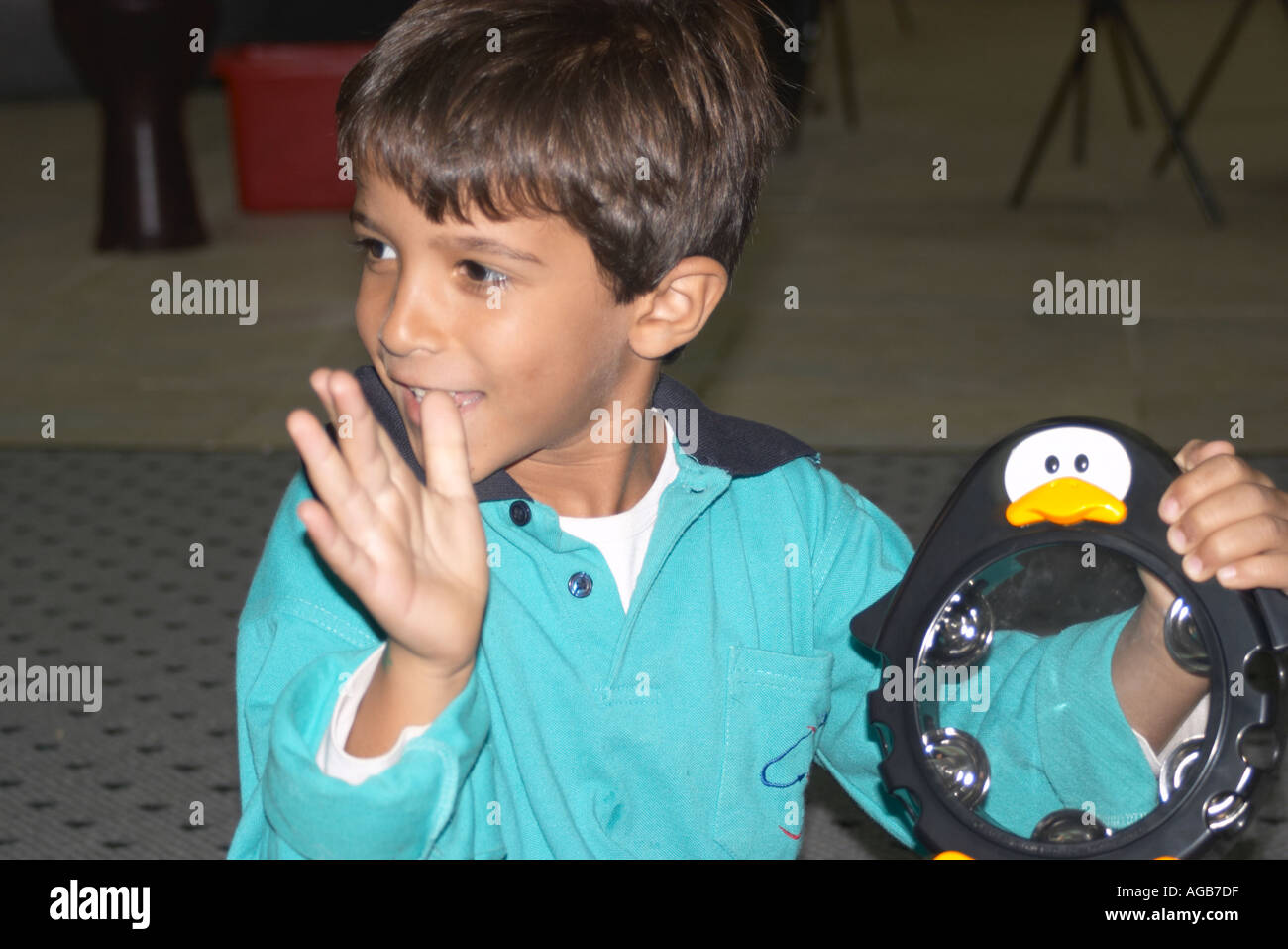 school boy using tambourine Stock Photo Alamy