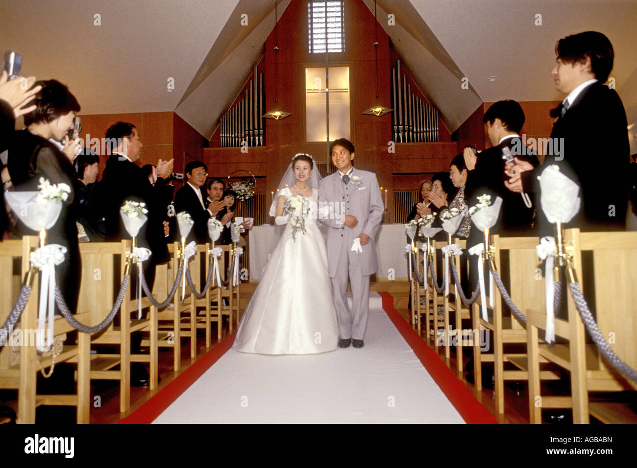 A Japanese wedding couple in Catholic church within a Hotel wearing