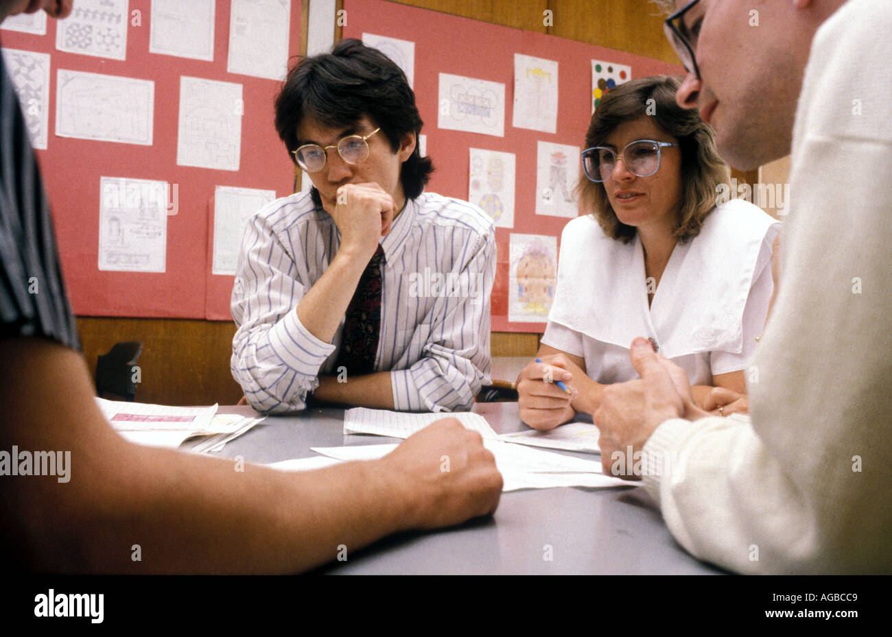 School teachers discussing their day's work during staff meeting. Stock Photo