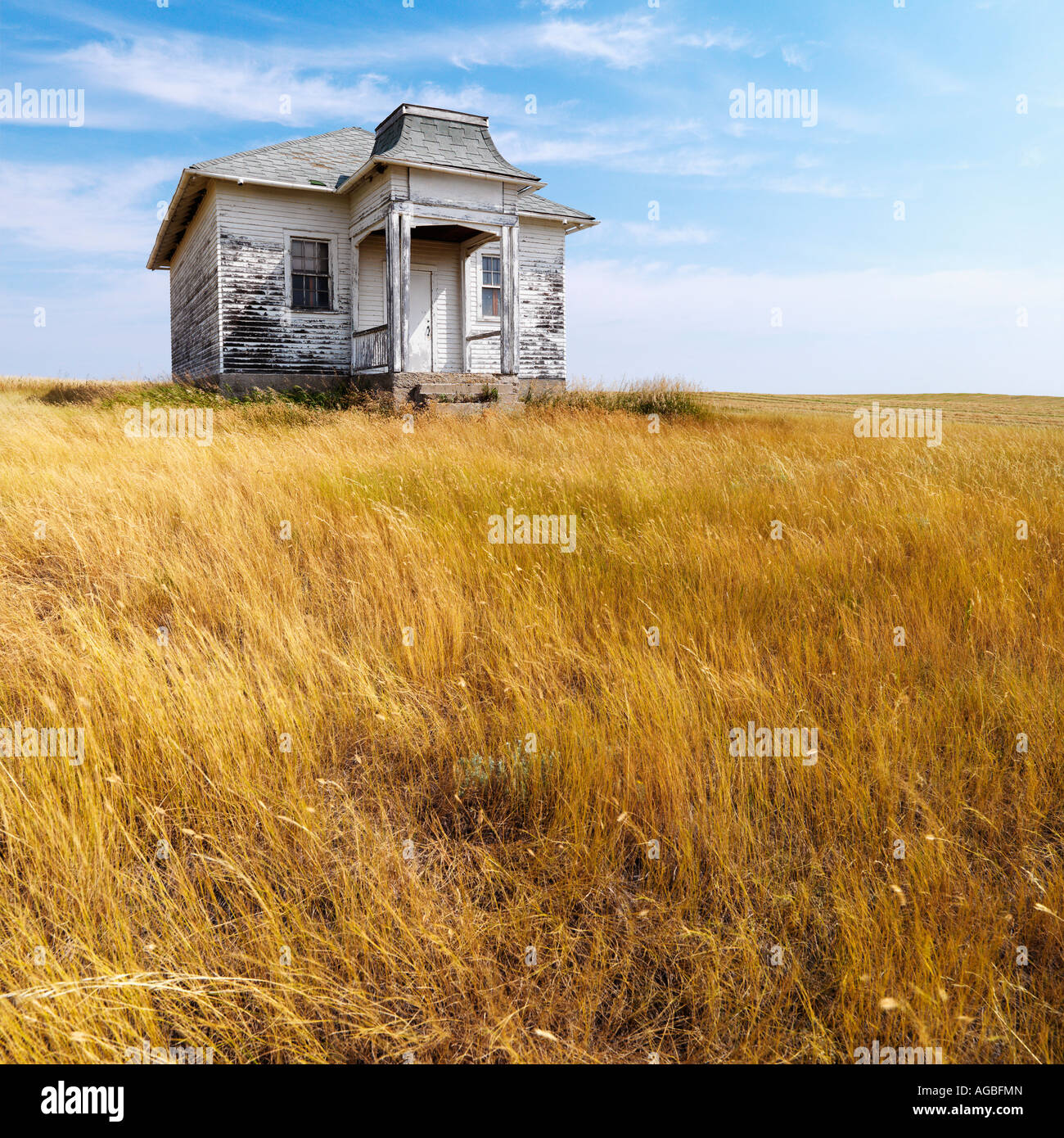 Weathered abandoned building in remote grassland Stock Photo