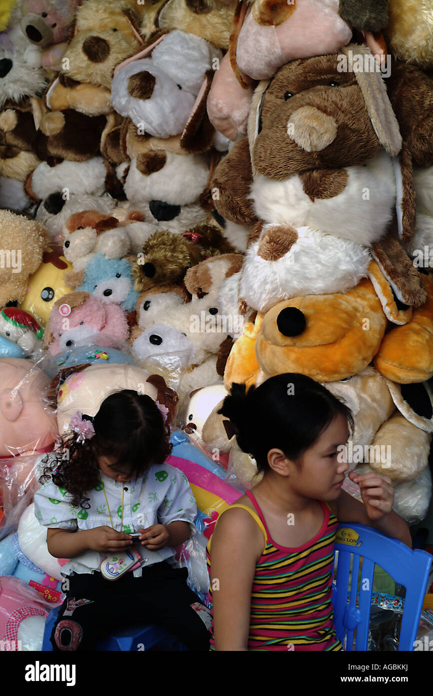 Two small Vietnamese girls in a teddy shop or toy store Stock Photo Alamy