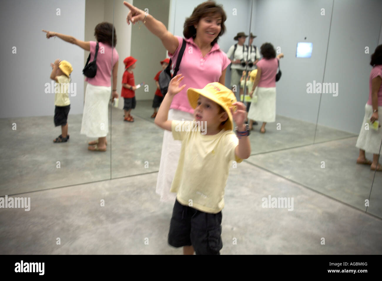 Family enjoying installatin with mirrors in Museum of Contemporary Art