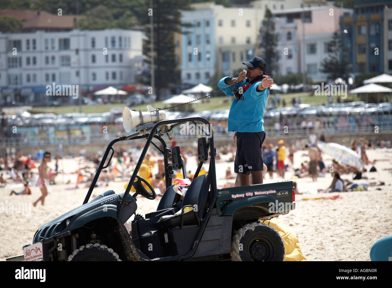 Surf rescue lifeguard calling swimmers on load hailer on Bondi Beach ...