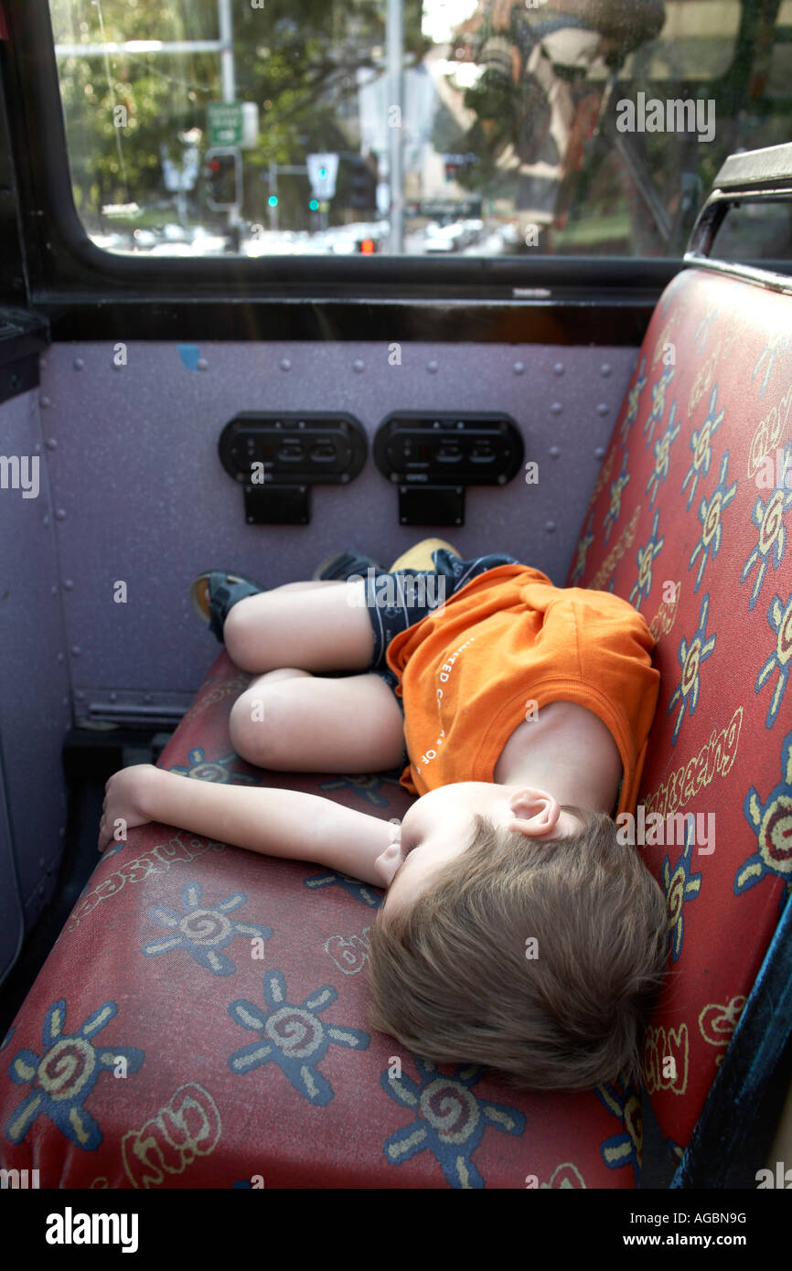 Young boy child asleep on a bus in Sydney New South Wales NSW Australia