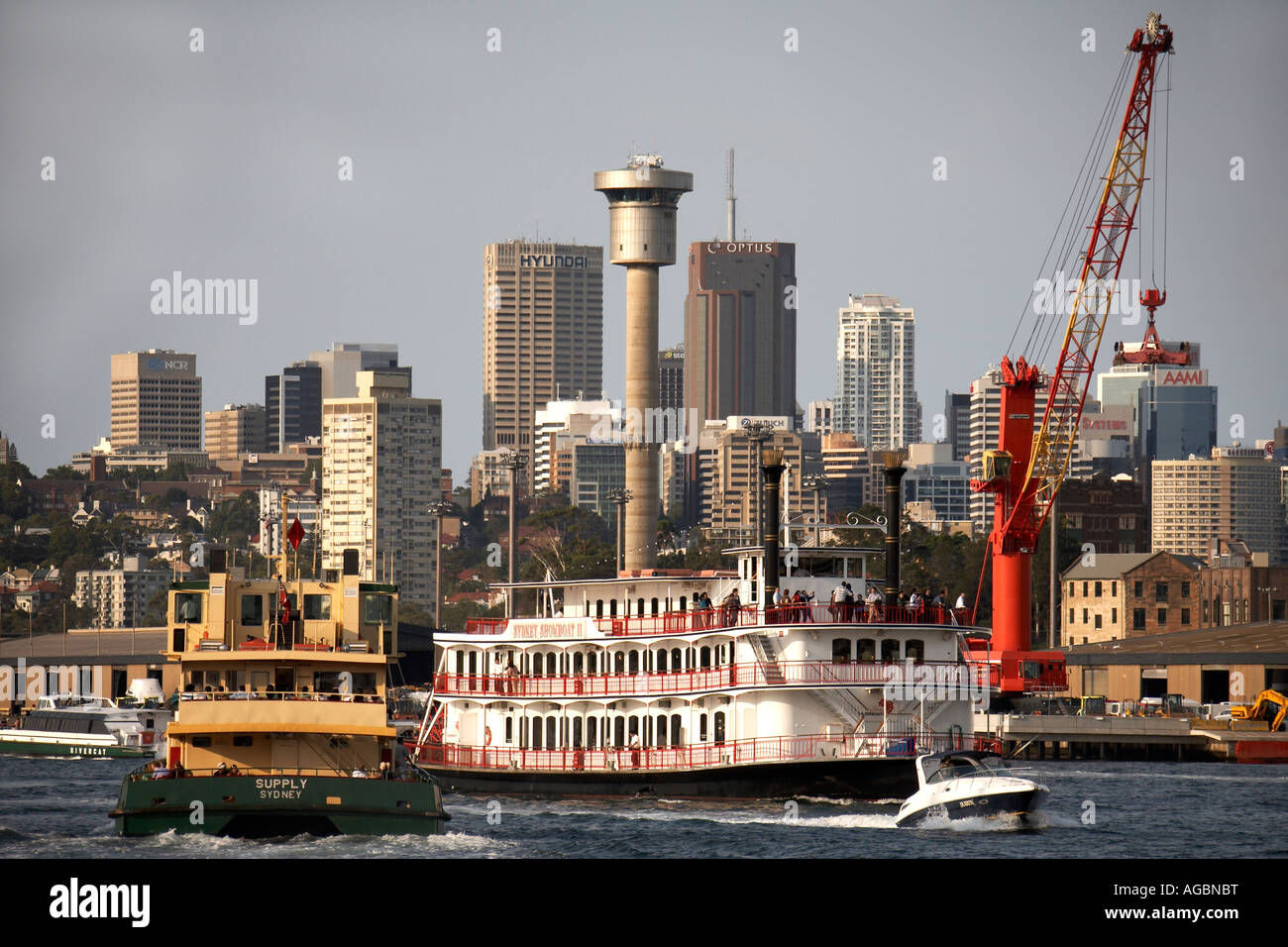 Ferry and paddle ship boat on Darling Harbour northern business district buildings skyline Sydney New South Wales NSW Australia Stock Photo