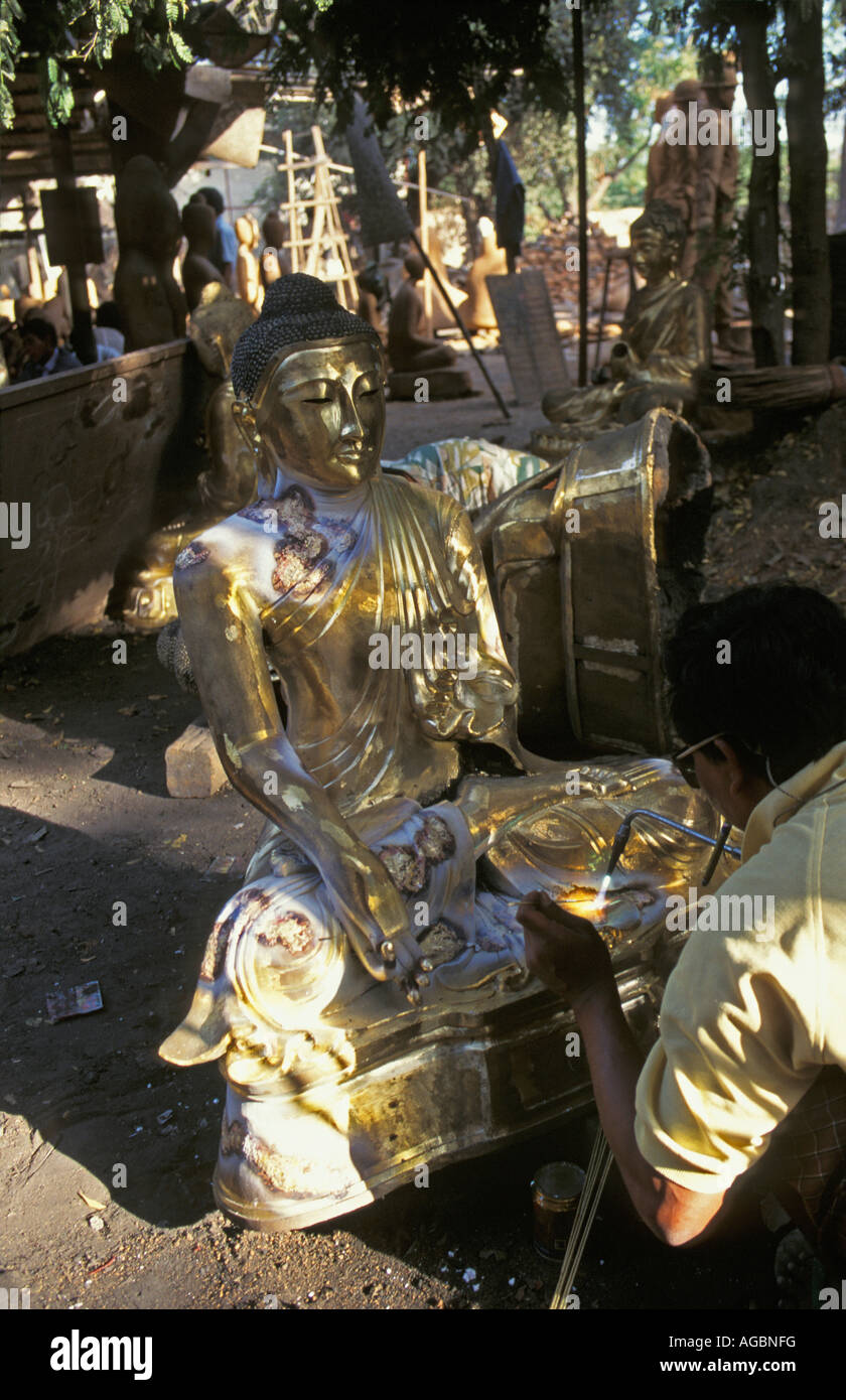 Myanmar, Mandalay, Man making bronze Buddha statue Stock Photo Alamy