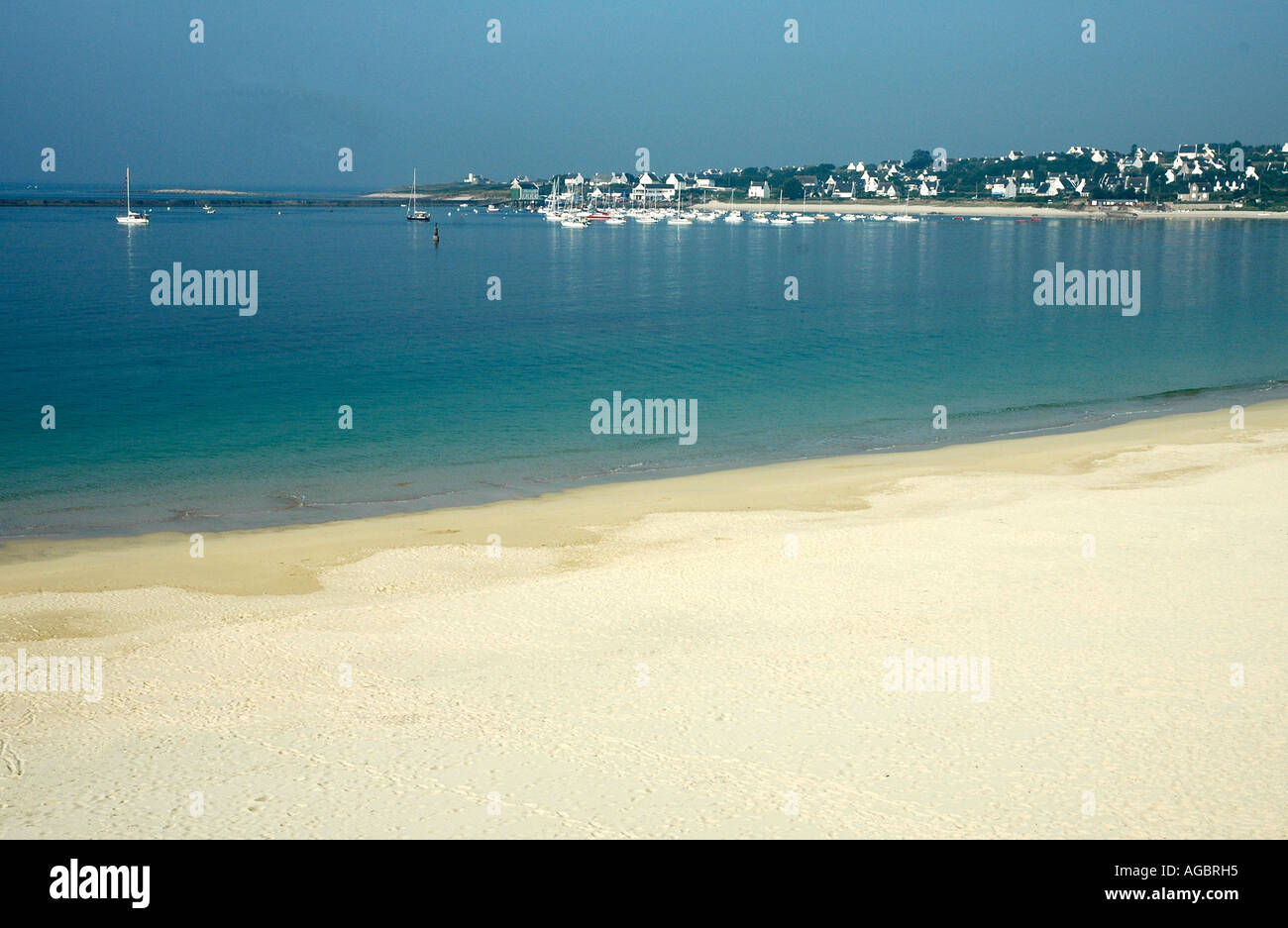 A dazzling beach in a dream bay beckons where the Finistère port of Audierne meets the sea Stock Photo