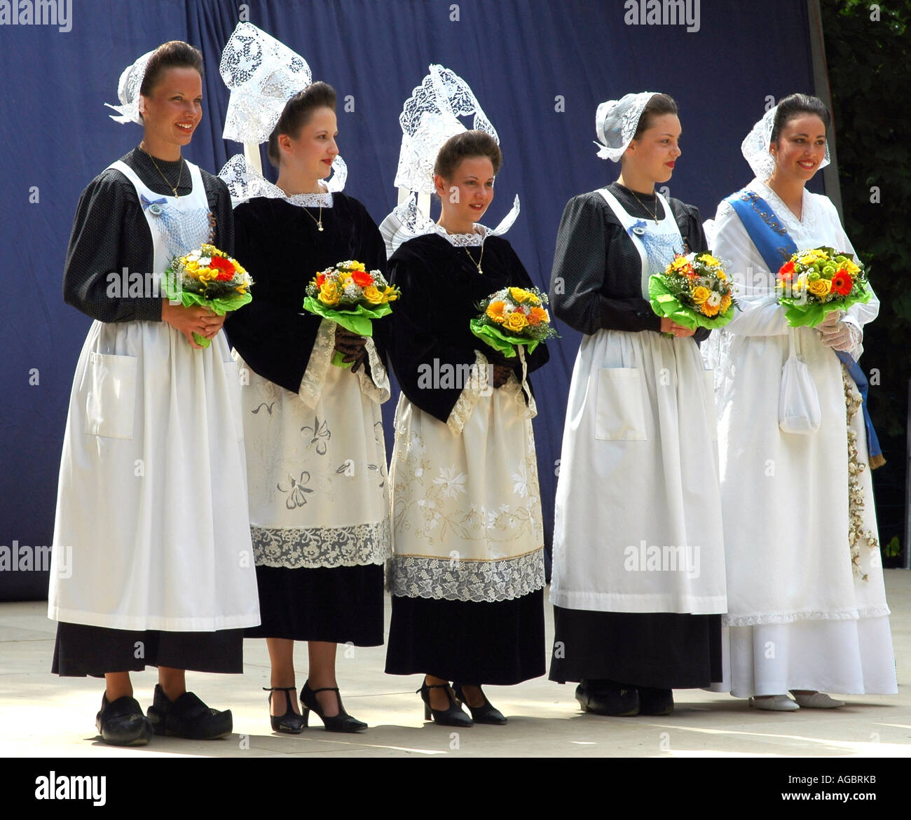 Five young women in classic Breton costumes at a summer folklore ...