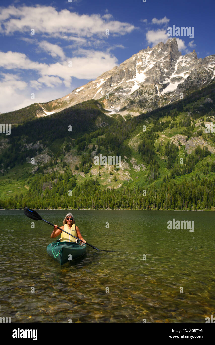 A visitor kayaking on Jenny Lake Grand Teton National Park Wyoming MR