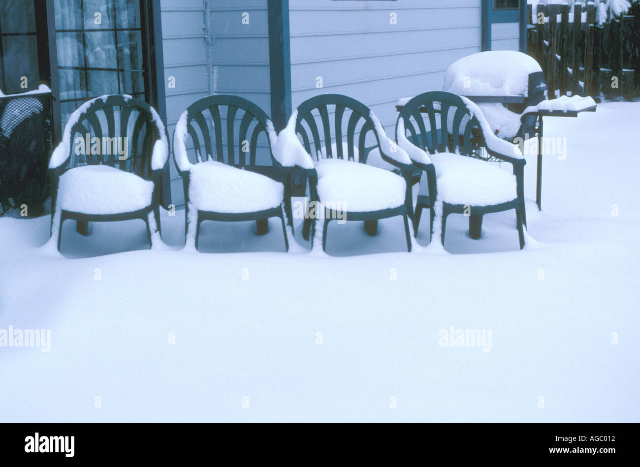 Snow fall on chairs Stock Photo