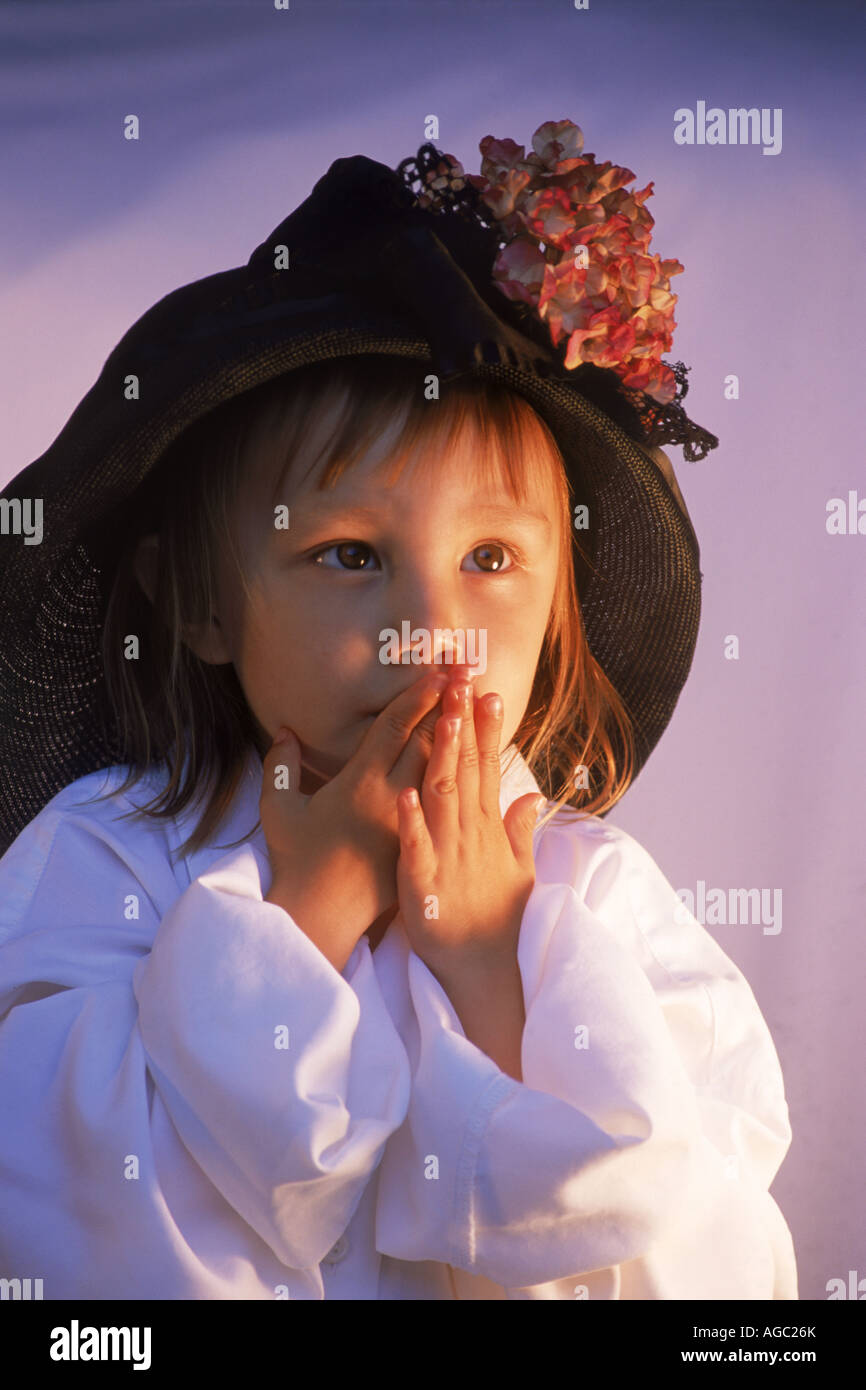 Little lady 2-3 years old with big stylish hat and white shirt Stock Photo