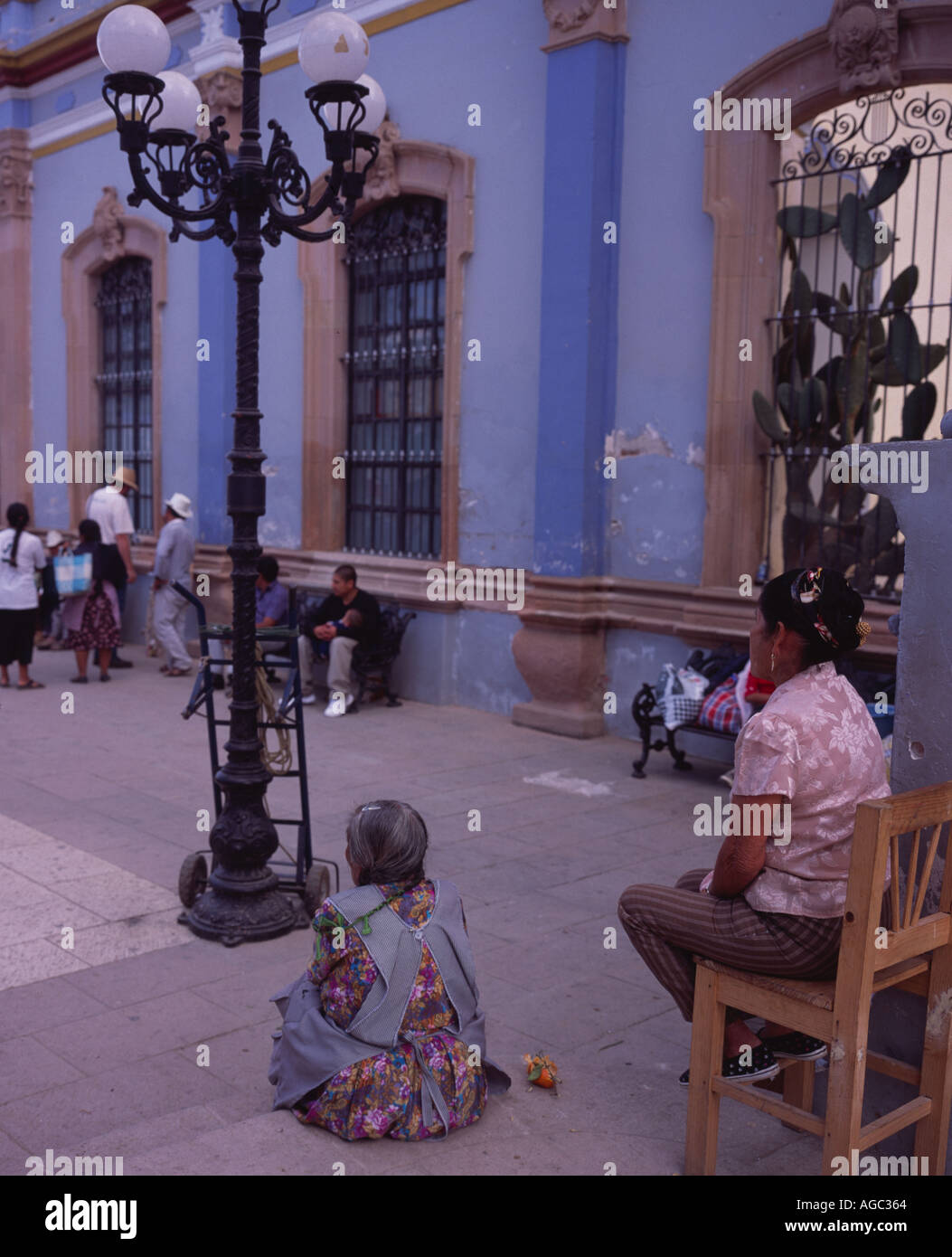 Local people sitting outside the church Ocotlán de Morelos, Oaxaca Mexico Stock Photo