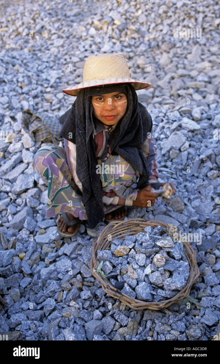 Myanmar, Yangon, Girl collecting stones for road construction Stock Photo