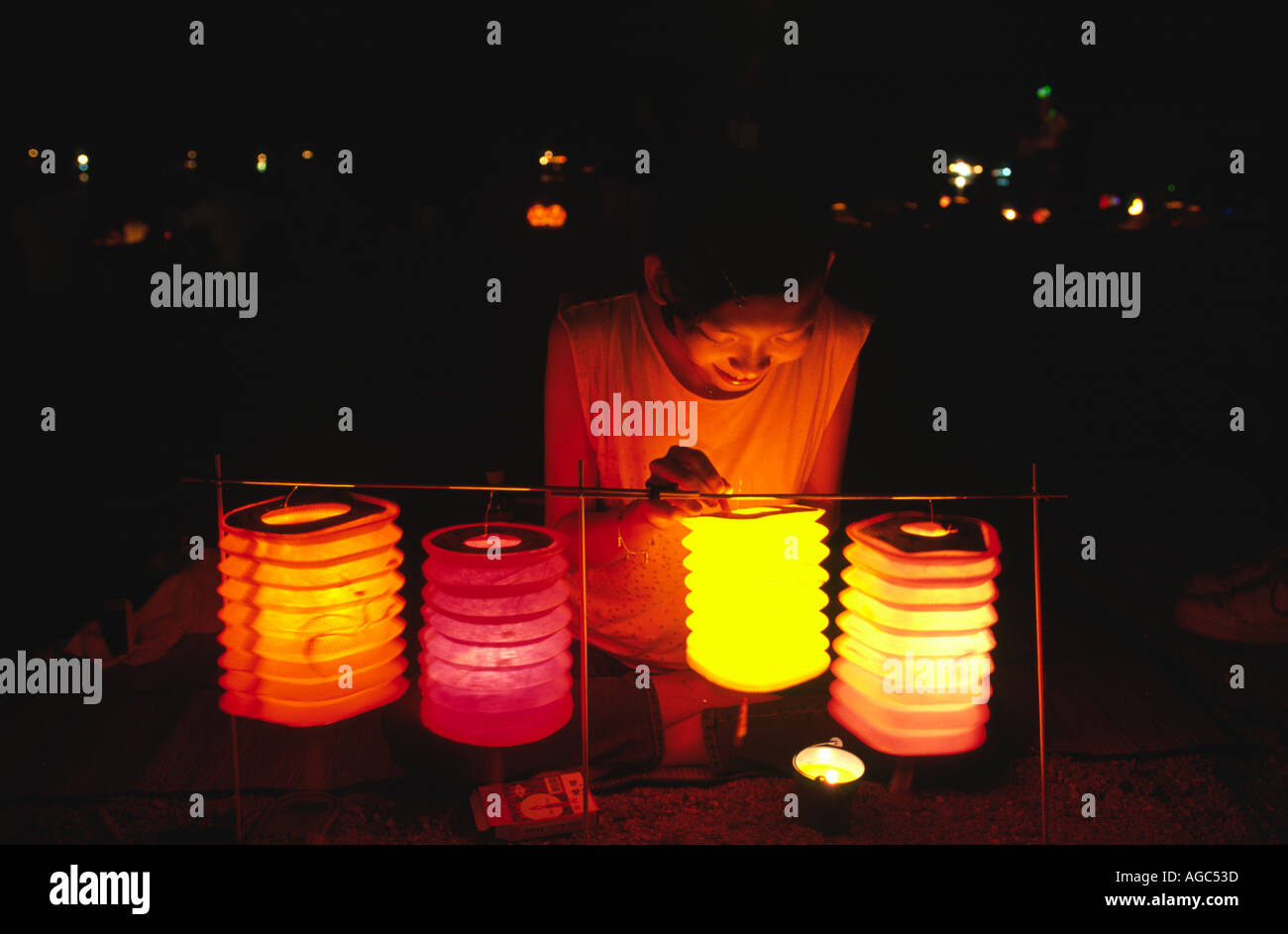 An adolescent girl lights a Chinese lantern during the mid autumn ...