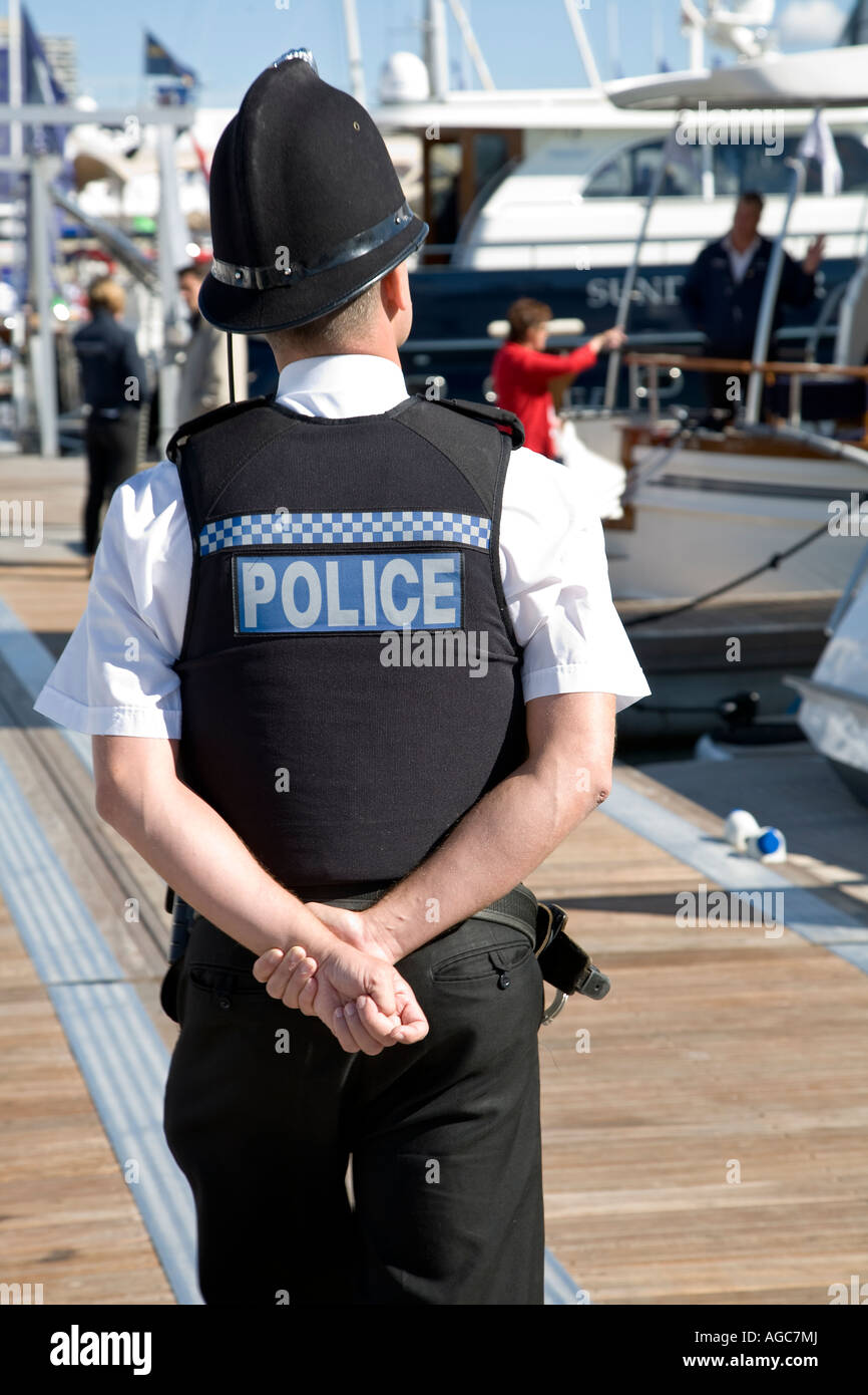 Young police officer patrolling marina in the summer Stock Photo