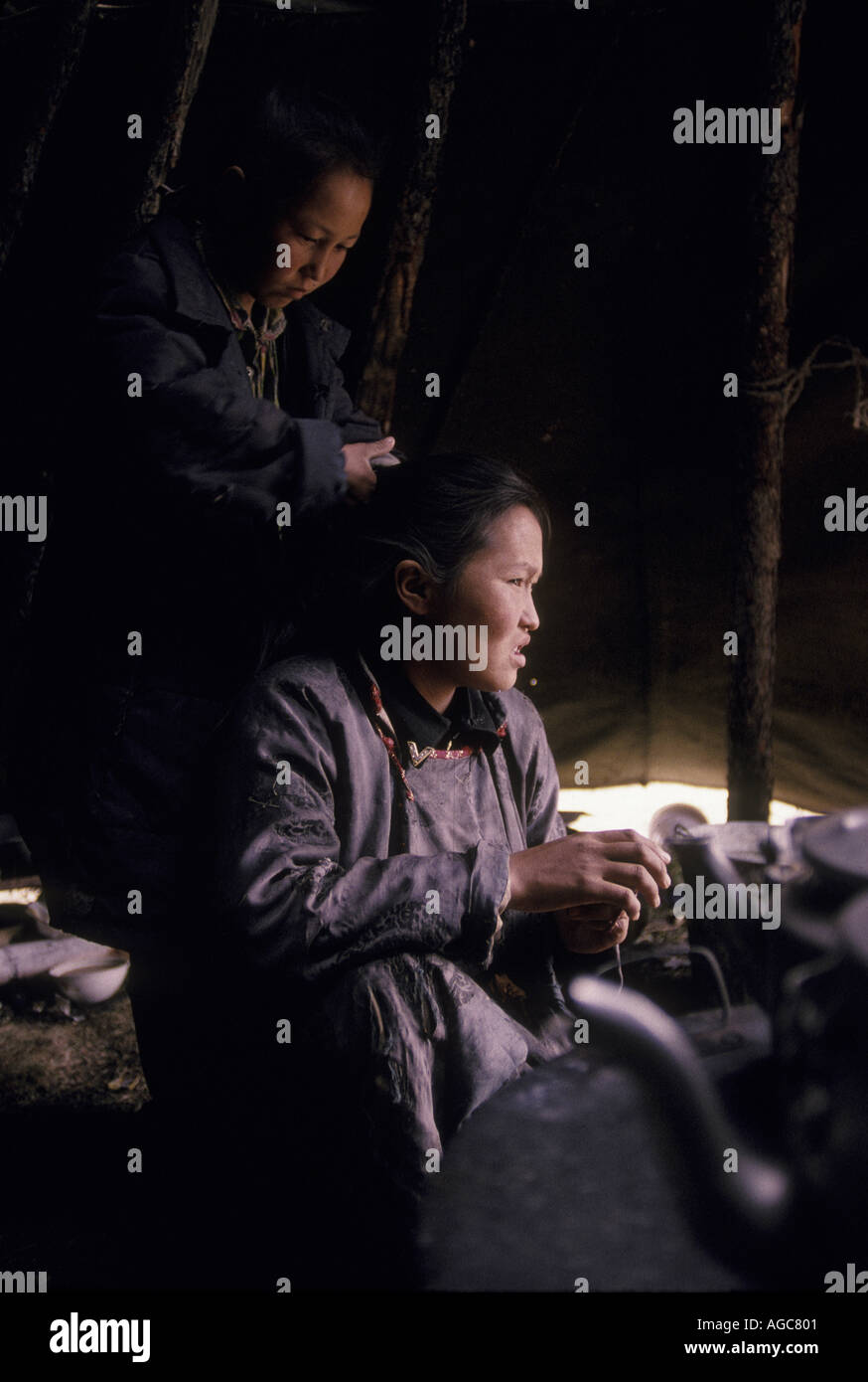 Mother and daughter Inside a Tsaatan family wigwam teepee in Northern outer Mongolia Russian border  Stock Photo
