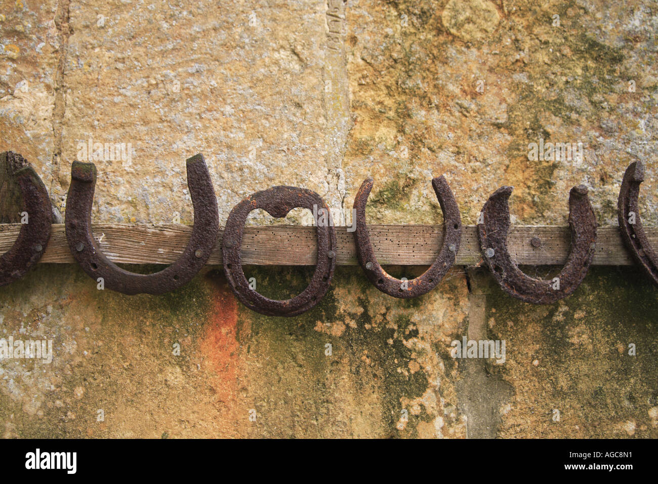 Horseshoes Hanging on a Cotswold Wall Stock Photo