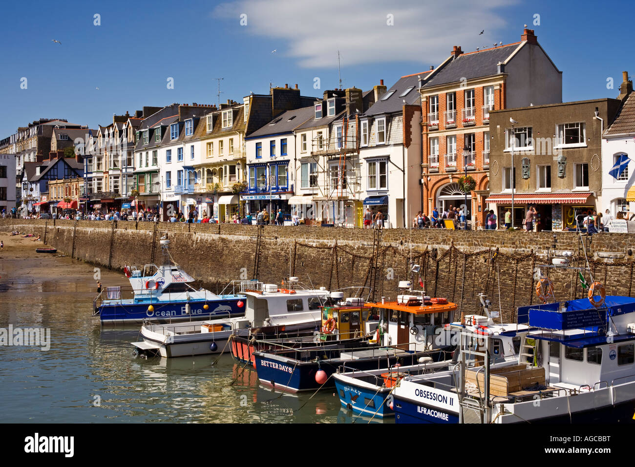 Devon town with tourists at harbour in summer UK