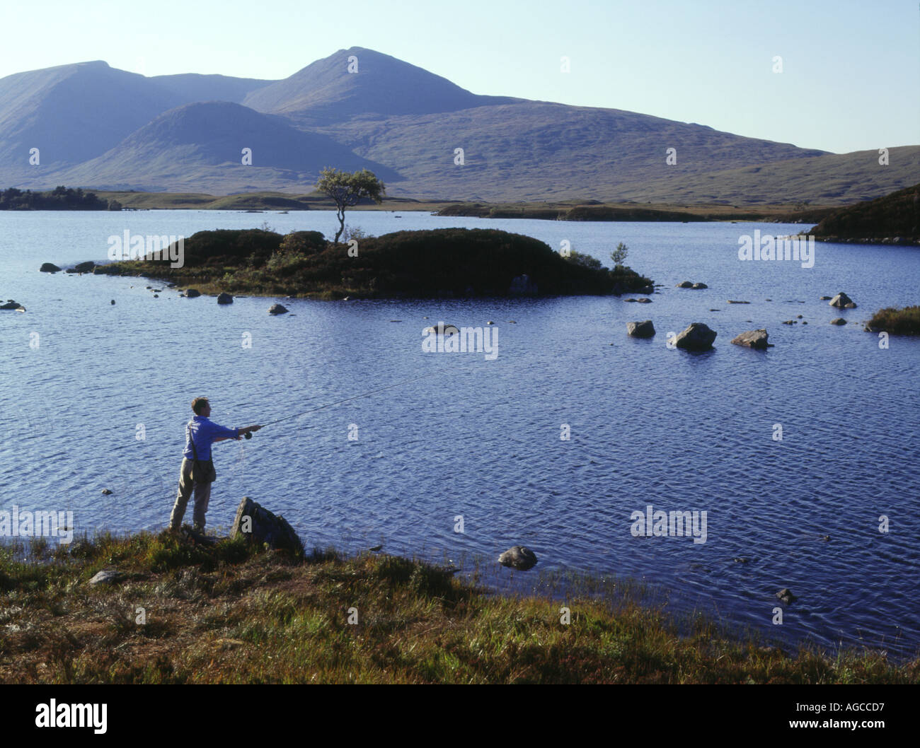 dh Lochan na h Achlaise RANNOCH MOOR ARGYLL SCOTLAND Angler loch casting fly fishing line freshwater lake Highlands uk angling mountain people Stock Photo