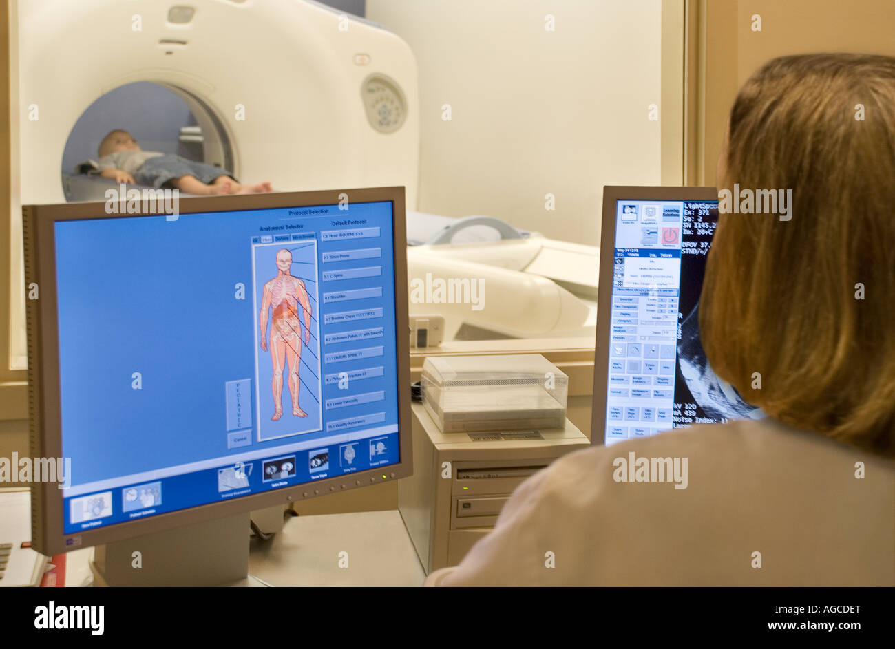 Young boy having CAT scan in hospital scanning suite from point of view of technician Stock Photo
