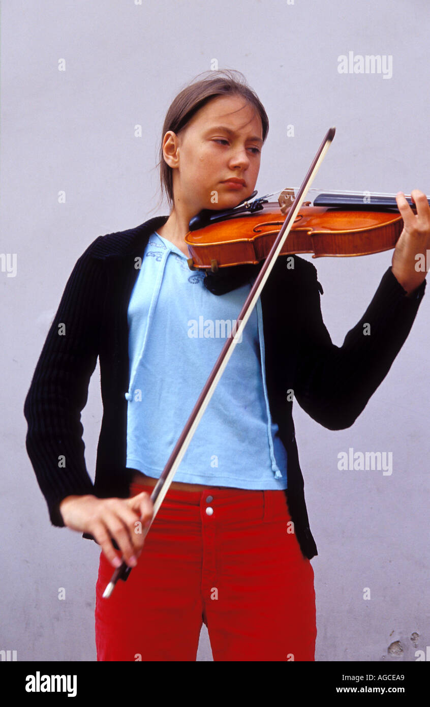 Young girl playing a Violin at Didzioji Gatve translate main street in the old city Vilnius Lithuania  Stock Photo