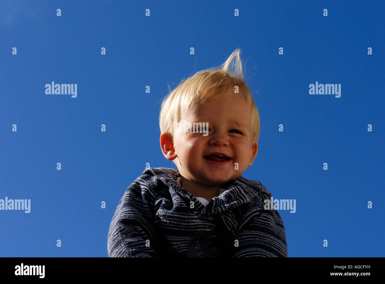Portrait of smiling baby boy against blue sky Stock Photo - Alamy