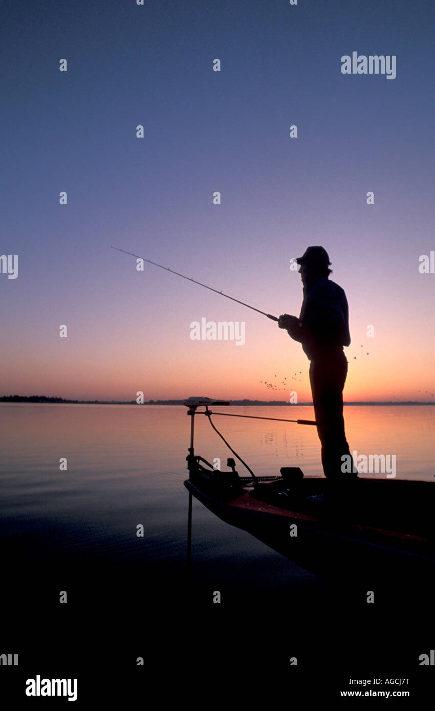 silhouette bass fishing sunrise sunset fisherman holding rod blue sky Stock  Photo - Alamy