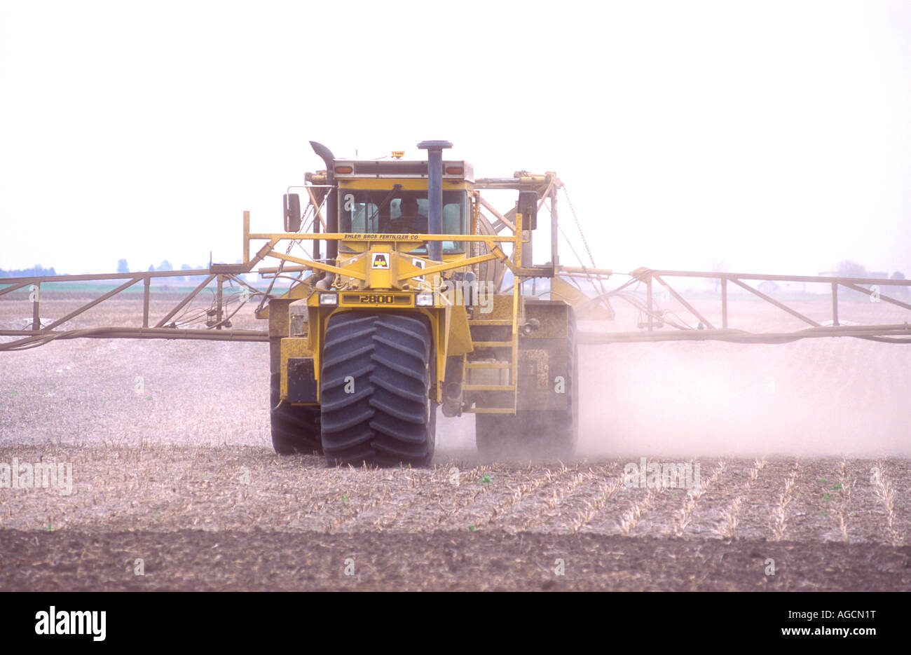 Spraying a farm field with herbicide or insecticide chemicals Stock ...