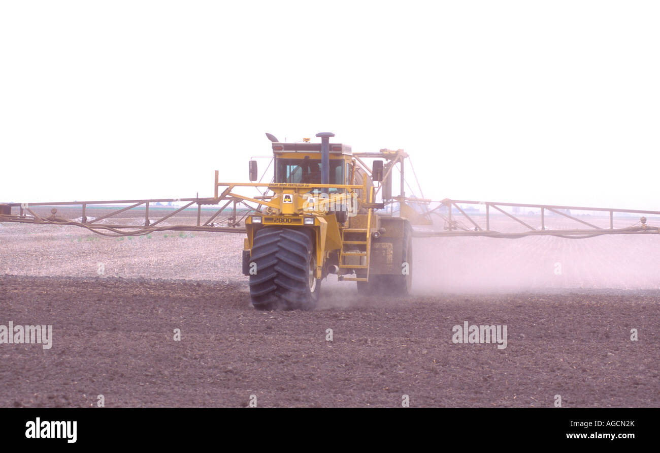 Spraying a farm field with herbicide or insecticide chemicals Stock ...
