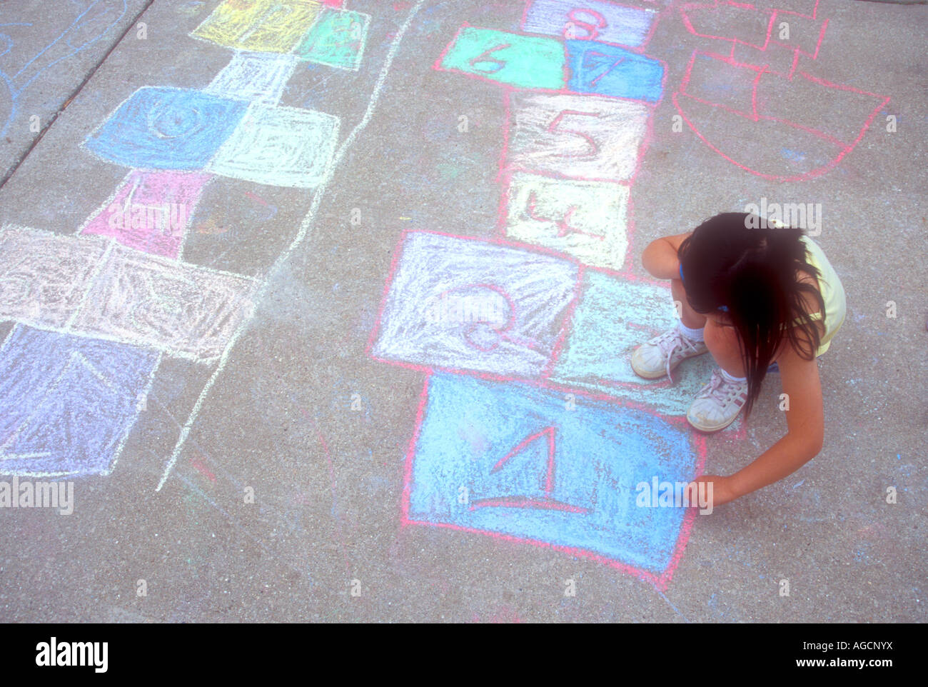 Asian girl writing with chalk on sidewalk Stock Photo - Alamy