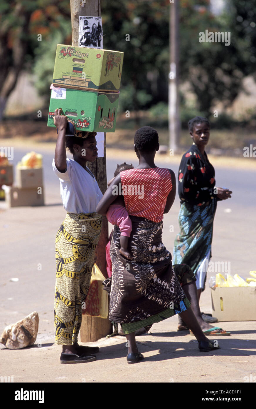Zambia Africa Lusaka women with boxes on head Stock Photo