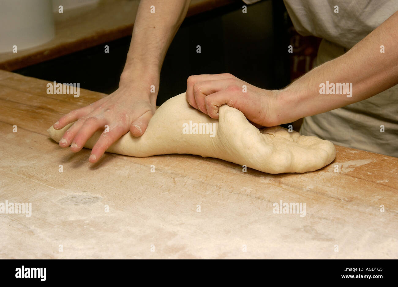 Baker kneading bread dough Stock Photo