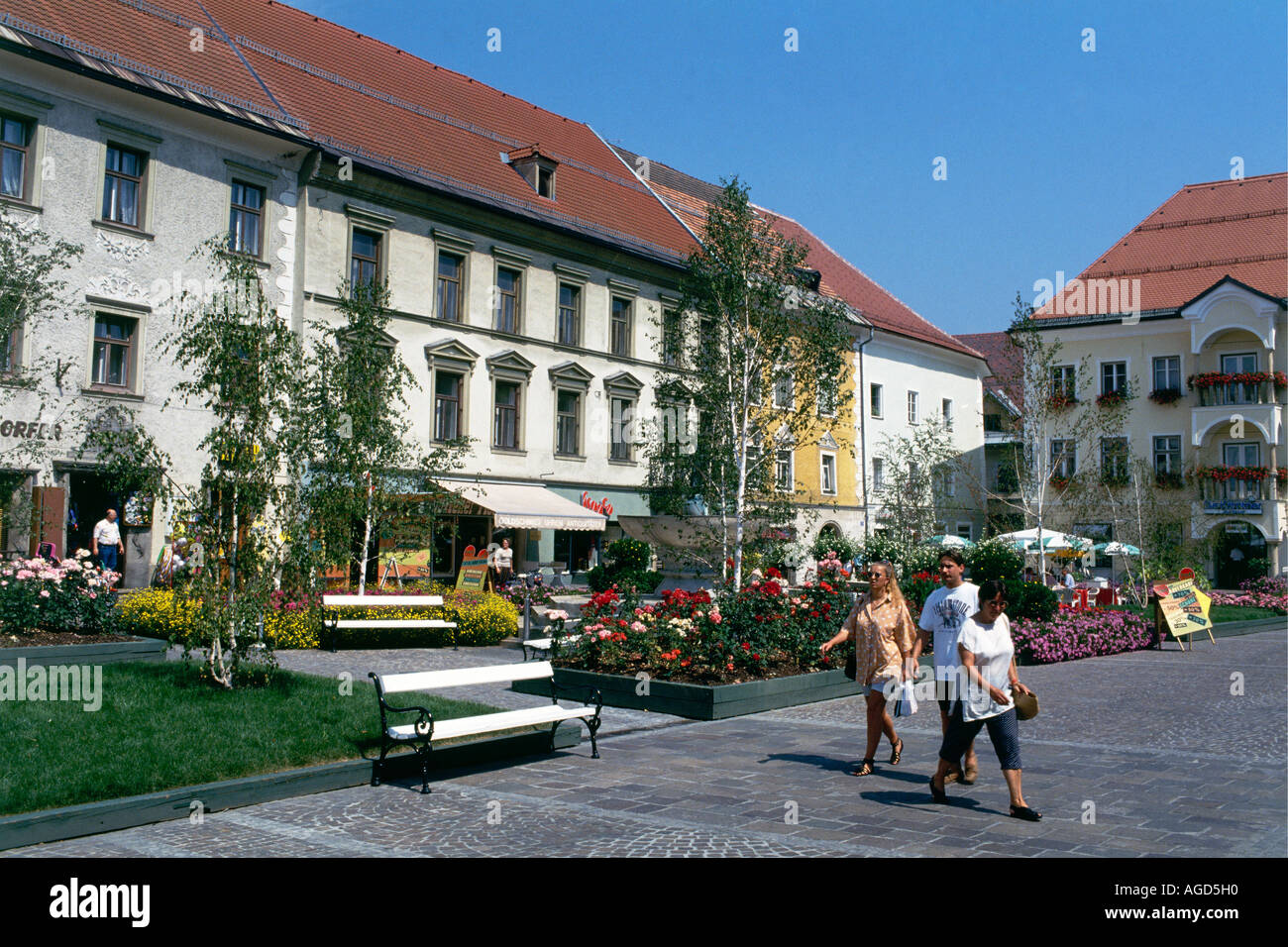 People beside the flowerbeds in the Hauptplatz of the old town of St Veit an der Glan former capital of Carinthia Stock Photo