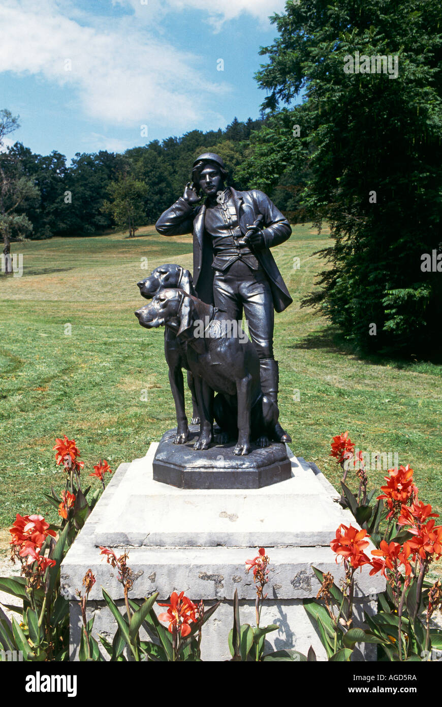 Statue of a man with two dogs in the parkland grounds of the Kaiservilla Imperial Villa the summer residence fo the Emperor Francis Joseph 1 in the small spa town of Bad Ischl Stock Photo