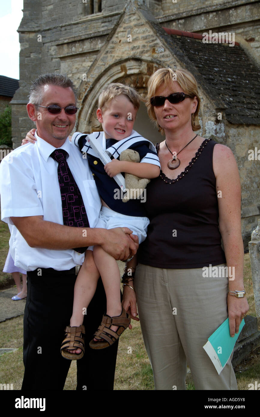 Christening ceremony. Church of England UK. Proud parents with their