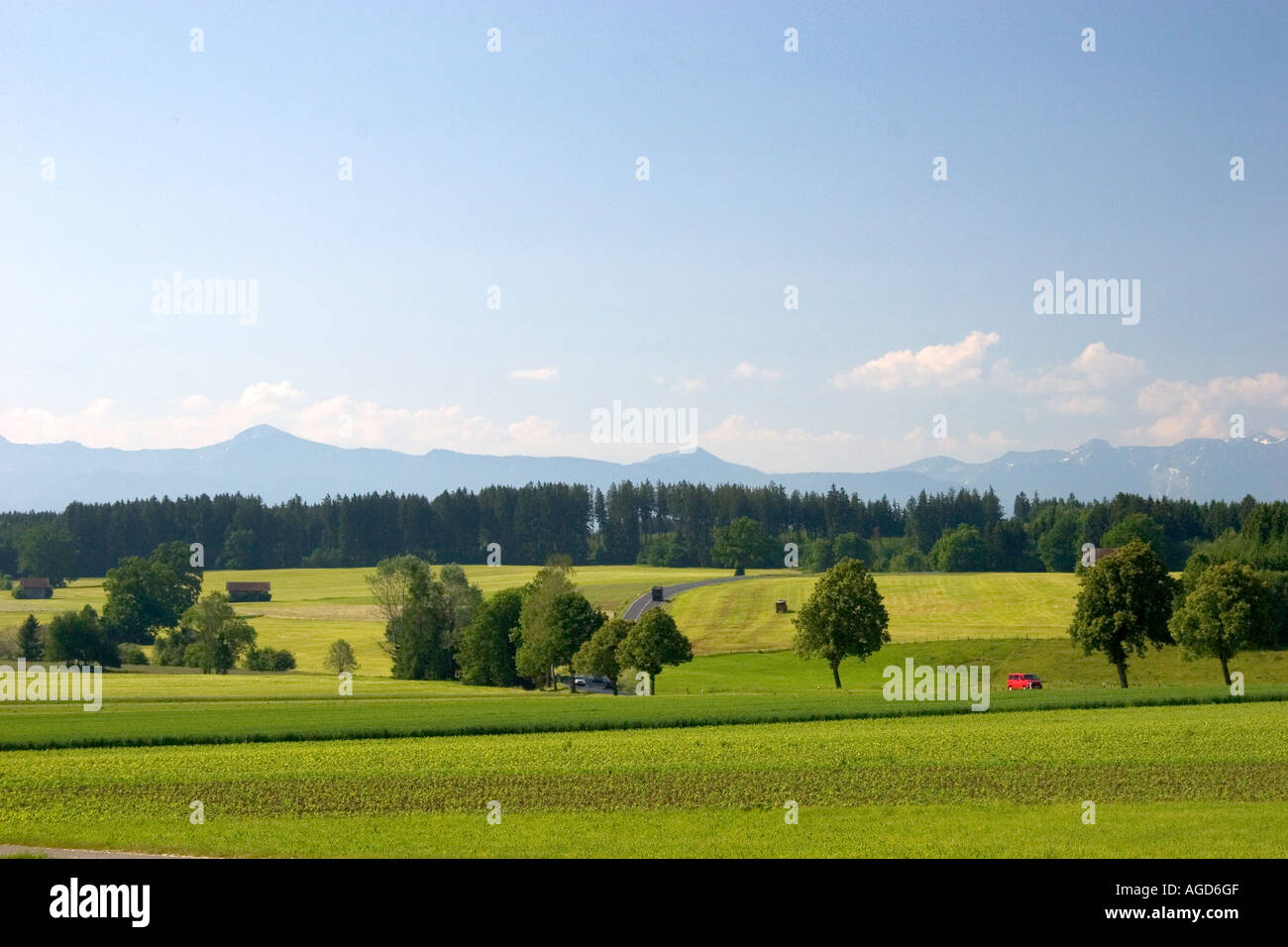 Austrian Alps and green fields near Weilheim in Southern Germany. Stock Photo