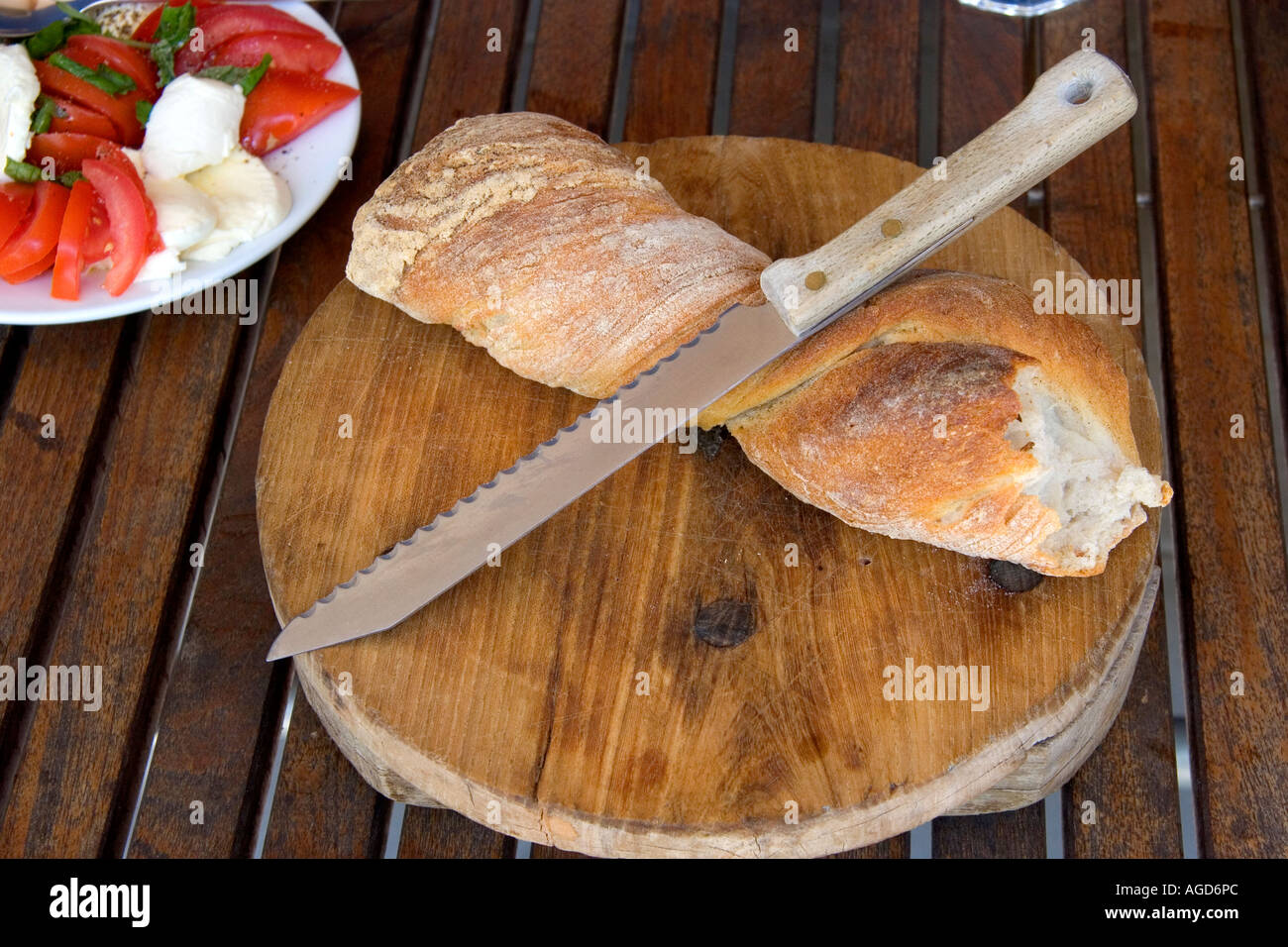 Bread and knife along with light lunch in Switzerland. Stock Photo