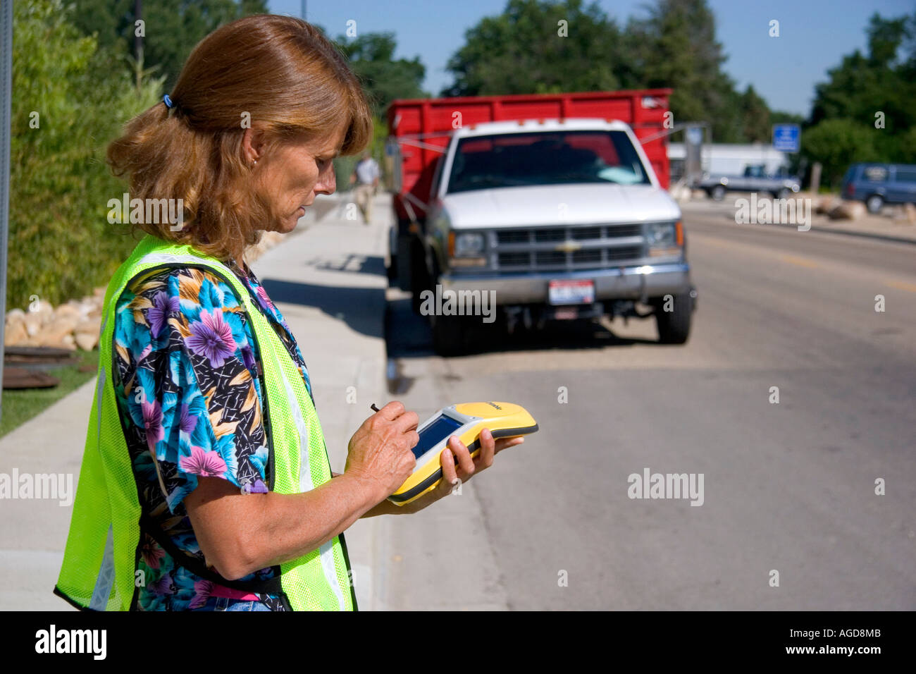 A woman using a handheld GIS device in the field, Boise, Idaho Stock