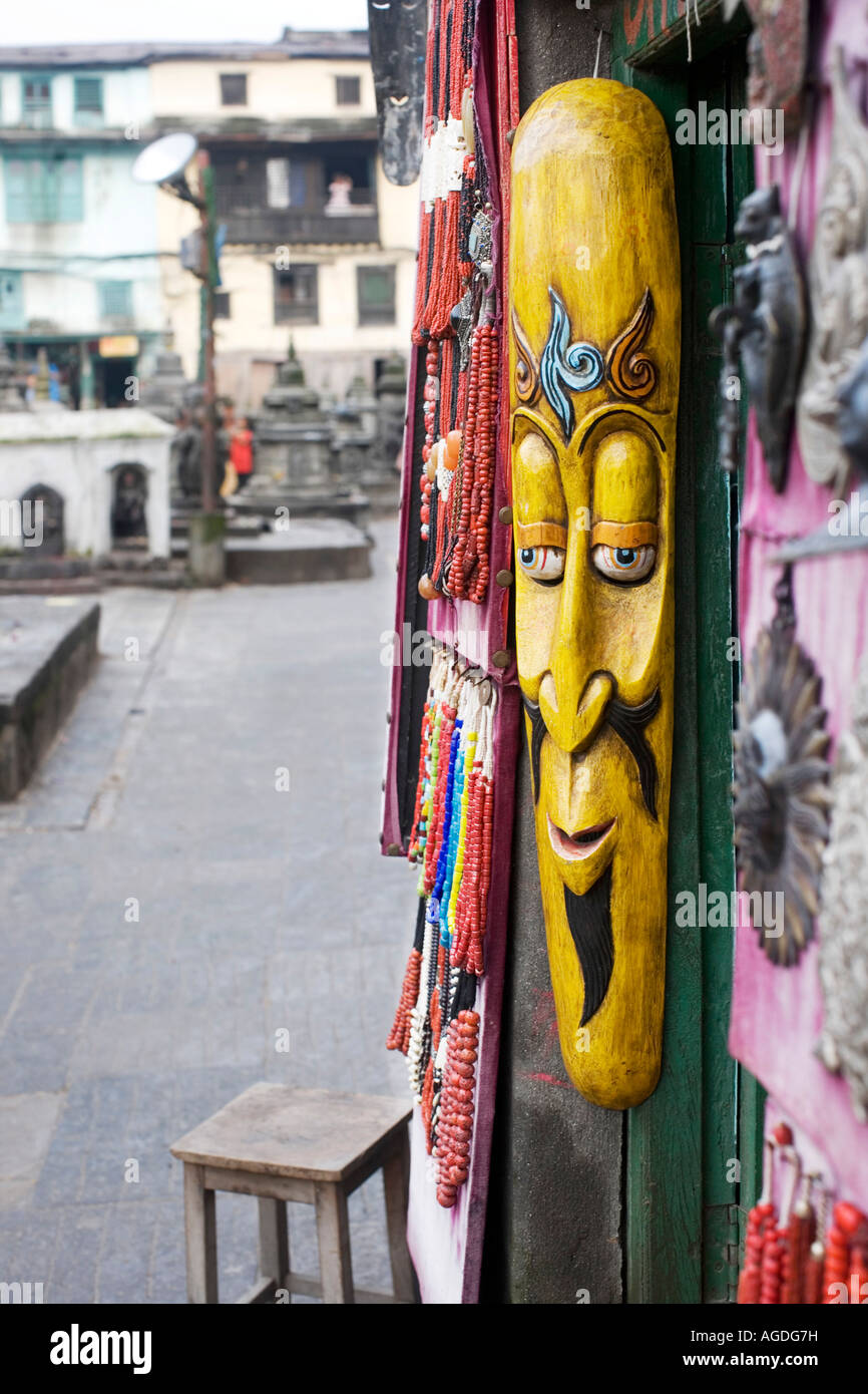 Long carved wooden face mask on a shop front. Swayambhu Stupa, Kathmandu, Nepal Stock Photo Alamy